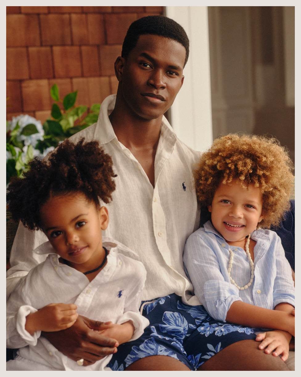 Man and children wear white and light-blue linen shirts.