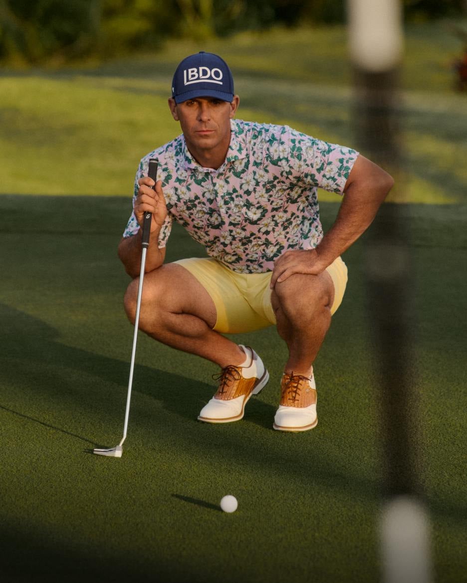 Billy Horschel on course wears floral-print Polo and yellow shorts.