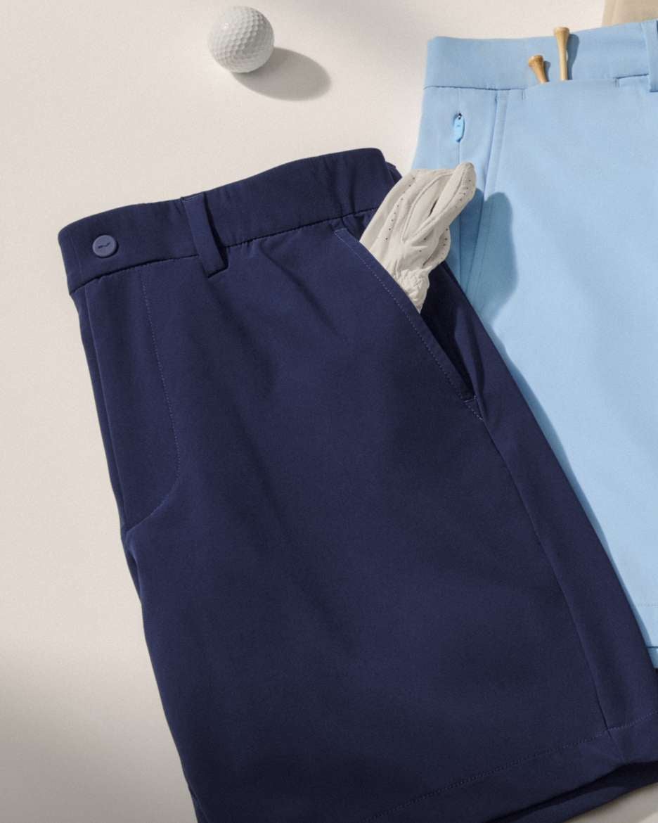Close-up of waist tabs of golf pants in various hues.