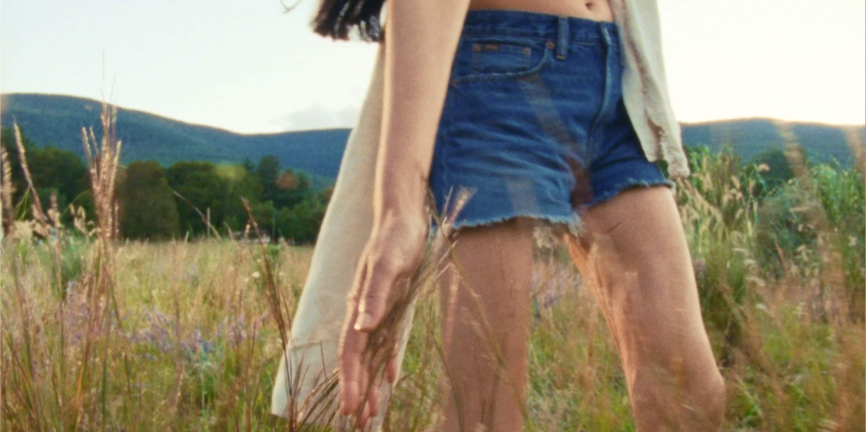 Video of men and women in grassy field.